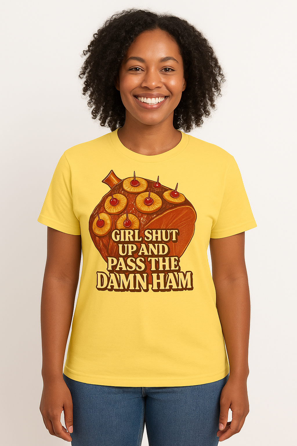 Person wearing a t-shirt with a graphic design and text on a white background. It has a picture of a ham and says Girl Shut Up And Pass The Damn Ham.